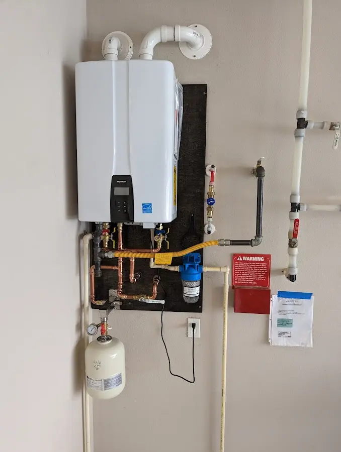 Professional plumber installing copper piping in a New Franklin home